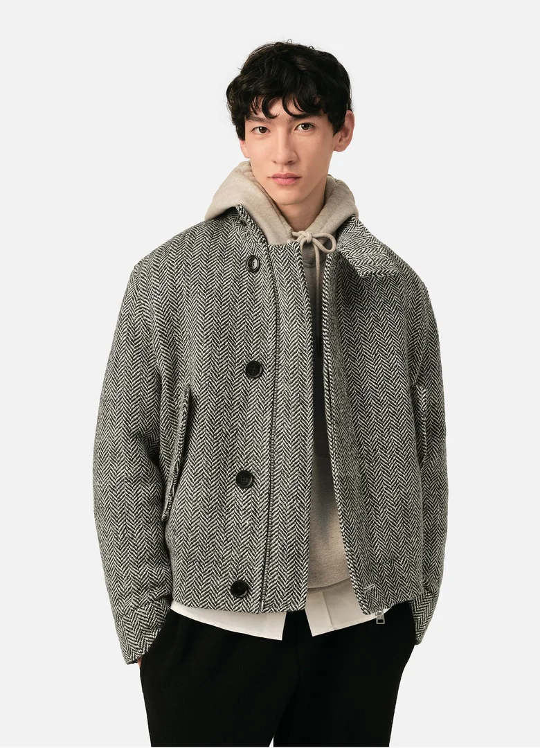 Blouson Harrington homme Ami Paris en laine à chevrons rembourré, porté sur un hoodie beige